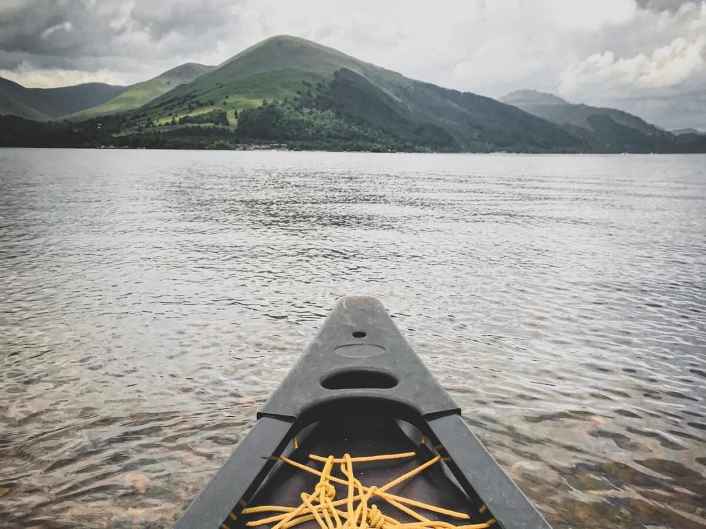 An image showing someone that is canoe wild camping in Scotland